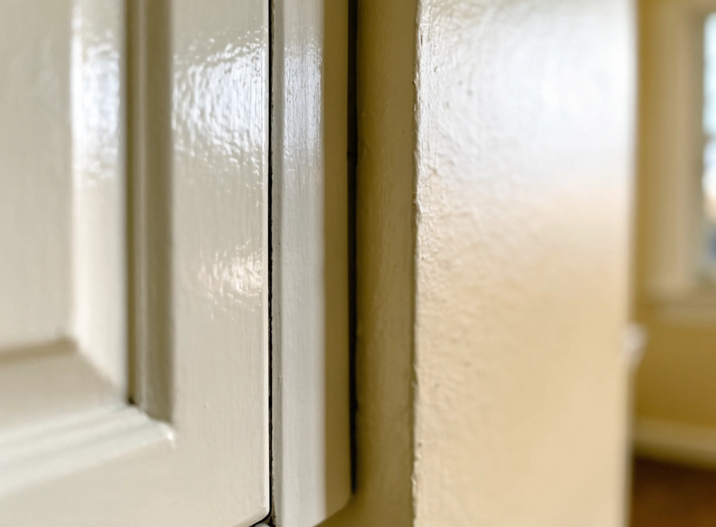 A three inch filler strip closing the gap between a stock cabinet and the wall, painted to match and still visible